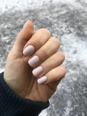 Sierkussen Nagelstudio Beautiful nude manicure with light beige nail polish close up  © Stanislava