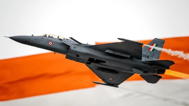 Military aircraft in flight against national flag backdrop high definition image