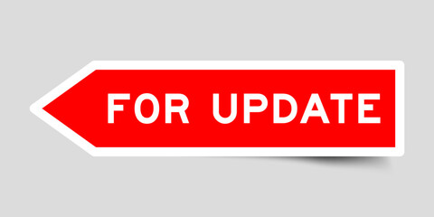 Red color arrow shape sticker label with word for update on gray background