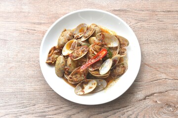 stir fried clams with roasted chili curry paste on plate 