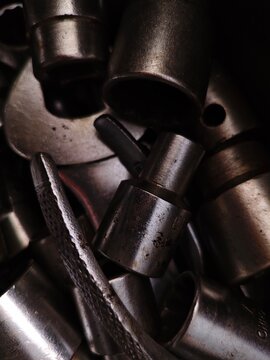 Closeup of Dark Oily and Used Socket Wrenches in a Pile Mechanic Tools.