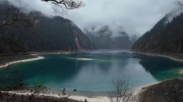 Jiuzhaigou, China: Dramatic view of the long lake on a foggy spring morning in the famous jiuzhaigou scenic area in the mountain of Sichuan in China