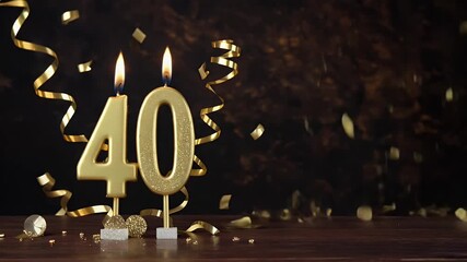 Golden 40th birthday candles with sparkling decorations on a wooden table, celebrating a milestone