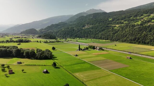 Scenic Aerial View of a Valley with Green Fields and Mountain Landscape in Switzerland near Flums, Berschis, and Walenstadt in the Canton of St. Gallen &ndash; Drone Footage