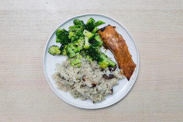 A plate of rice, broccoli, and salmon.