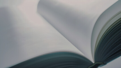 Abstract close-up of turning book pages in sunlight