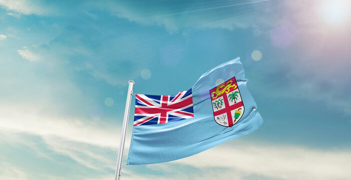 Fiji national flag waving with beautiful sky.