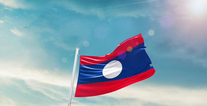 Laos national flag waving with beautiful sky. - Powered by Adobe