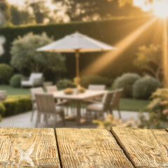 Wooden garden table with clean space for product placement. In the background, backyard setting behind house.  Summer outdoor grilling and eating concept.