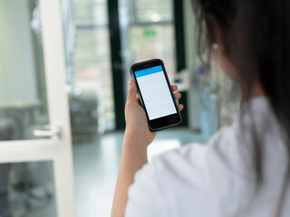 Medical staff member using mobile device for healthcare applications in modern hospital environment