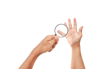Hand holding magnifying glass examining the other hand, depicting inspection or detail, against a clean white background