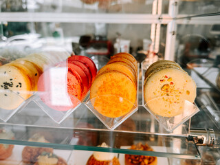 Colorful macarons displayed in a pastry shop in the afternoon sunlight