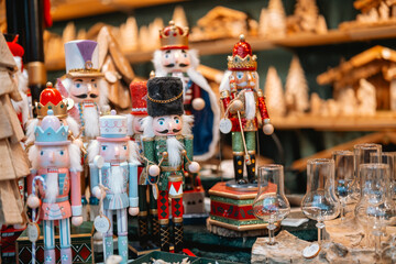 A colorful market stall filled with nutcracker dolls, angel figurines, and traditional handcrafted decorations