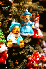 Colorful bear and tree ornaments on Christmas tree for holiday, childhood and festive mood concepts