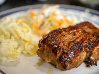 pork fillet with potatoes and salad in close up