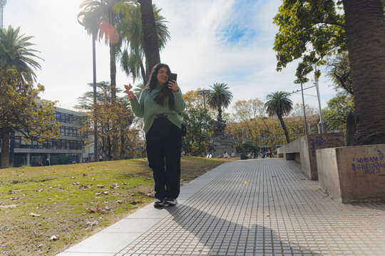 woman standing in the square sending a voice note