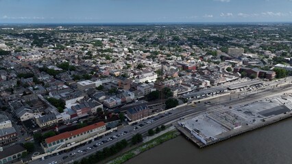 Obraz premium Aerial of residential urban neighborhood homes located in downtown New Orleans, Louisiana with streets and trees during summer heat wave