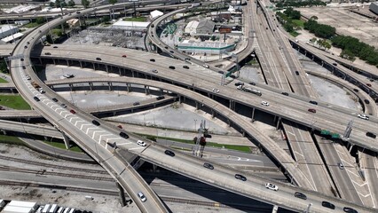 Aerial view of interstate highway exchanges with cars and trucks driving over industrial area of...