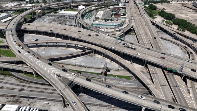 Aerial view of interstate highway exchanges with cars and trucks driving over industrial area of New Orleans, Louisana downtown traffic