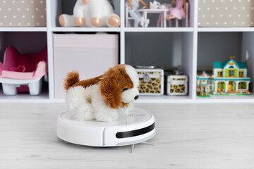 Close up the automated robot vacuum cleaner is cleaning the floor. Automatic electric cleaning inside the apartment. Robotic cleaner technology. Modern technologies in-house. Home cleaning