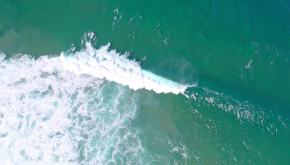 drone shot of a massive, cresting ocean wave