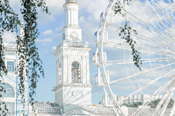 bright white architecture European city central square tower spire building with Ferris wheel...