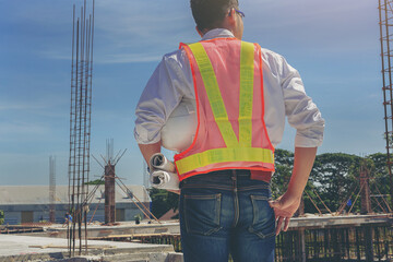 Smart civil architect engineer inspecting and working, command at outdoors building side with blueprints. Engineering and architecture concept