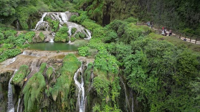 Italy, Umbria, Spectacular drone view of the Marmore Falls with water falling from above in a natural setting of unique beauty with pools of green water immersed in the lush nature