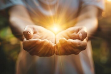 Woman cupping hands with glowing light, symbolizing spirituality, hope, and divine energy