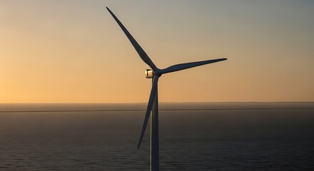 Wind turbine generating clean energy at sunset over sea
