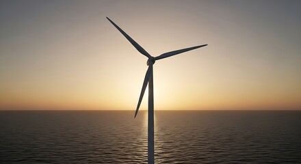Fototapeta premium Wind turbine silhouette against the sunset over the ocean