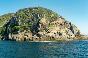 Rocky mountain by the sea and beautiful blue sky, located in the Cabo Frio region, Rio de Janeiro, Brazil.
