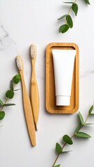 Overhead View of Toothbrushes Toothpaste and Eucalyptus Sprigs on a White Marble Surface