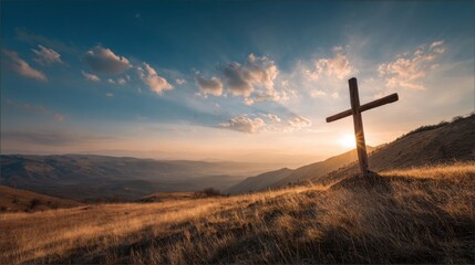 Scenic landscape featuring a wooden cross on a grassy hill during sunset with mountains in the background.