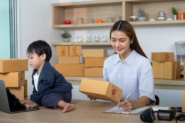 Sell Online: Busy mother managing e-commerce while caring for child