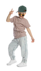 Happy little boy in sunglasses and baseball hat dancing on white background