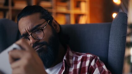 Happy young Indian man playing mobile video game at home, enjoying win - Powered by Adobe