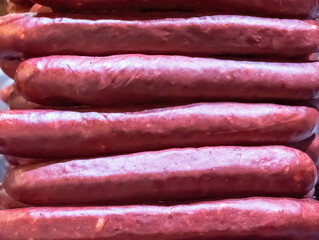 sausages with paprika, red sausages cooking on the grill selective focus