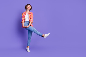 Full size photo of nice young girl dance empty space ad wear shirt isolated on violet color...