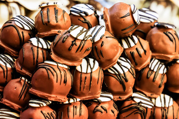 marzipan covered with dark chocolate glaze, confectionery counter with selective focus