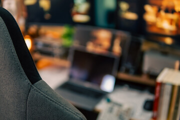 A warm and cozy desk setup featuring triple monitors, notebook, microphone, and green plants, styled in a minimalist Japanese aesthetic for creative work.