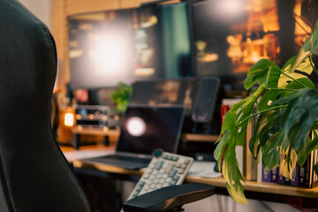 A warm and cozy desk setup featuring triple monitors, notebook, microphone, and green plants, styled in a minimalist Japanese aesthetic for creative work.