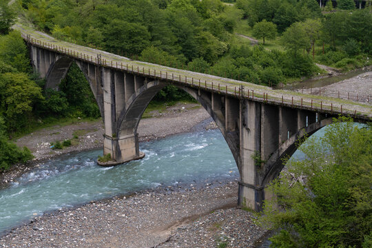 View of the old arched railway bridge on a May day. Tkuarchal, Abkhazia