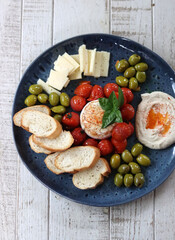 Italian antipasti with tomatoes, olives and cheese
