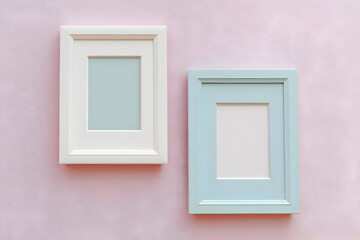 Aesthetic empty photo frames in white and light blue against a soft pink background. Perfect for home decor, art displays, or creative projects.