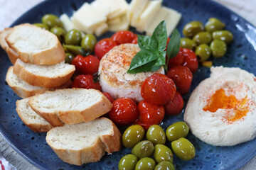 Appetizer with feta cheese, olives, tomato and bread