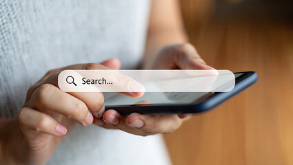 Person holding smartphone with search bar overlay for online information retrieval concept