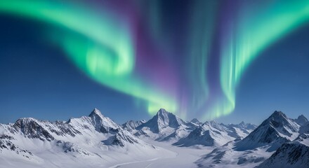 Aurora borealis over snow covered mountains against blue sky