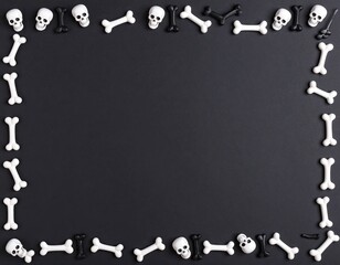 Black background bordered by white and black skulls and bones