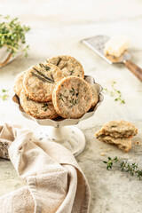 Shortbread cheese cookies with aromatic herbs on rustic textured background. Savory parmesan cookies for party